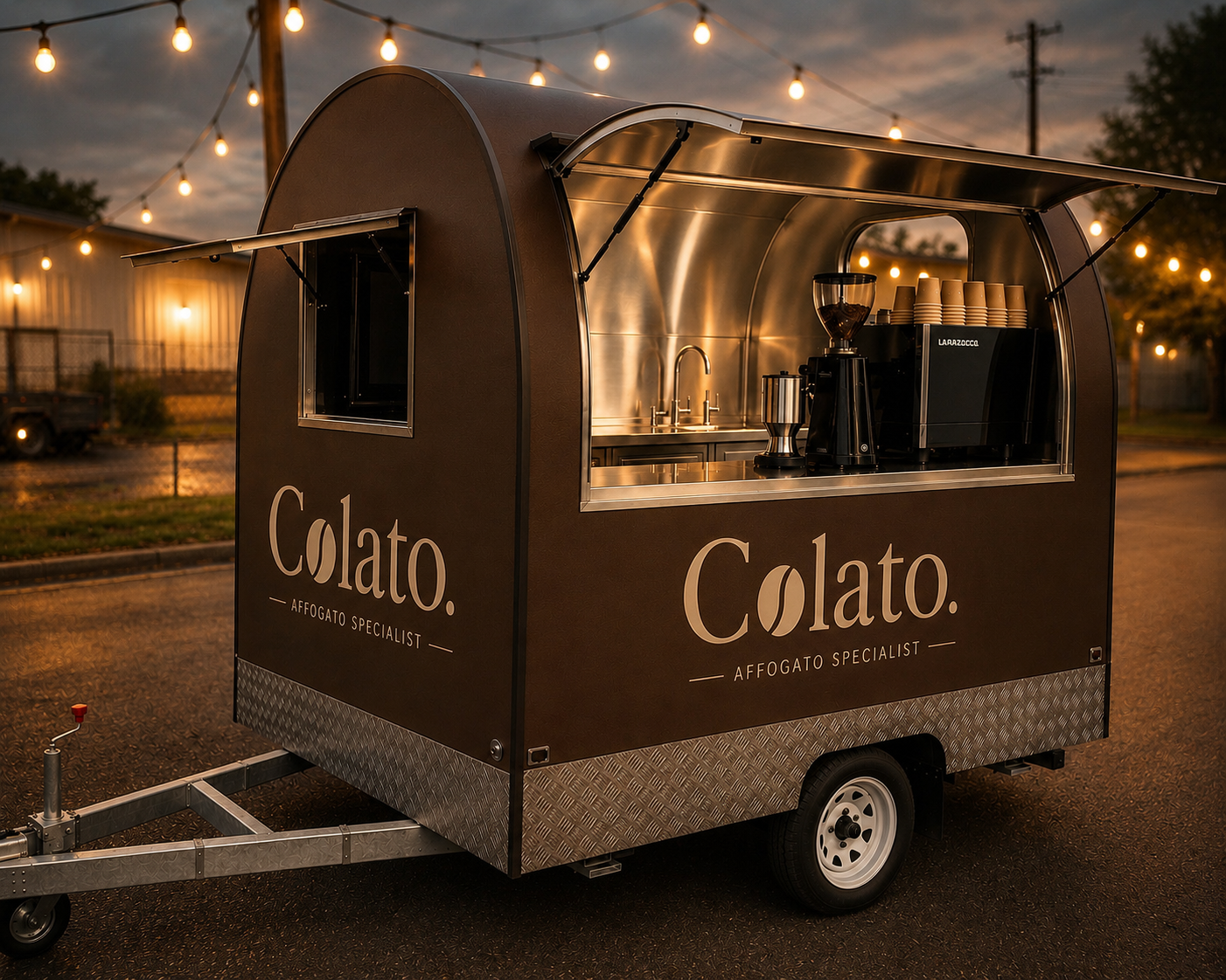 The Colato affogato trailer lit up at dusk with festoon lights